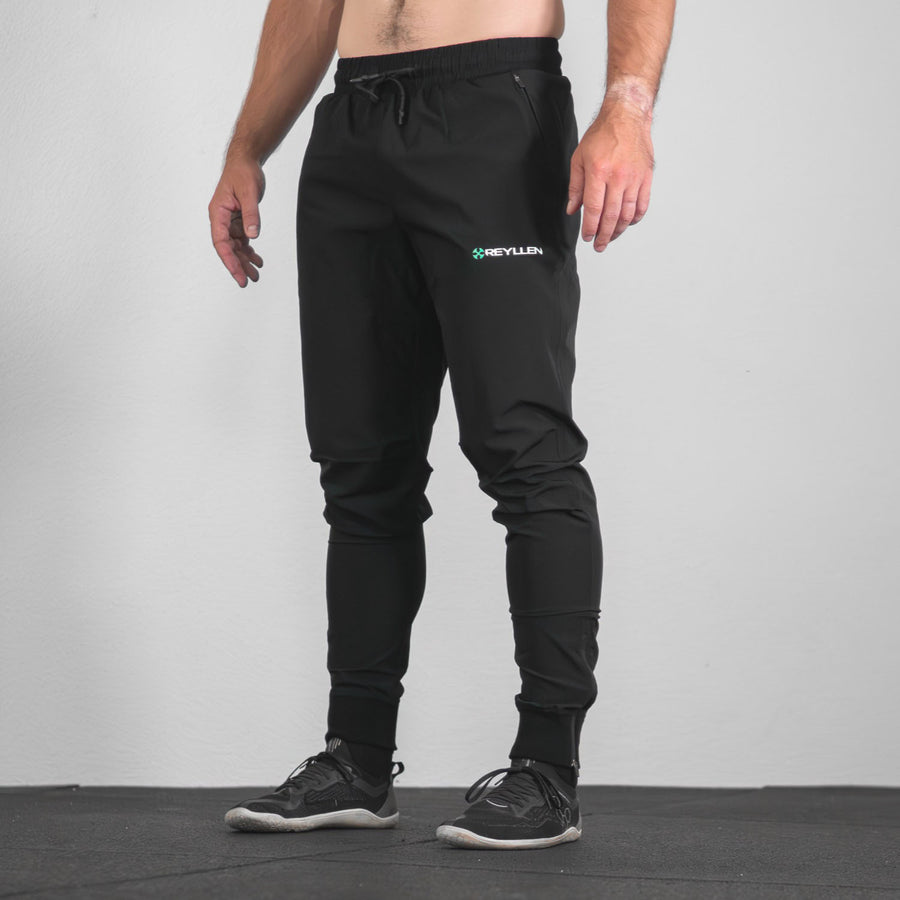 reyllen X1 unisex man woman joggers black nylon stretchy modelled by man bottom up side view