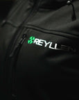 Reyllen Soft Shell Jacket Unisex Polyester Fleece Hood worn by woman front logo detail shot