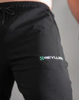 reyllen X1 unisex man woman joggers black nylon stretchy upper leg logo detail shot