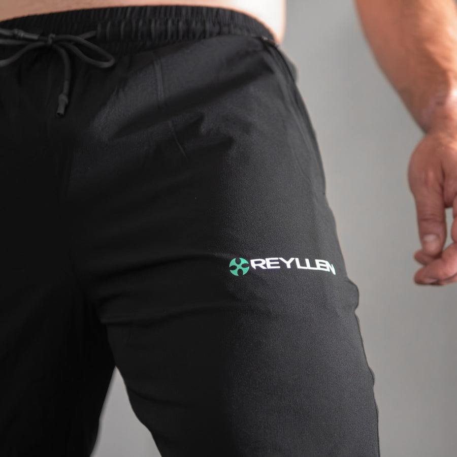 reyllen X1 unisex man woman joggers black nylon stretchy upper leg logo detail shot
