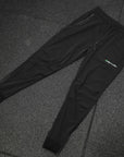 reyllen X1 unisex man woman joggers black nylon stretchy laid flat on floor