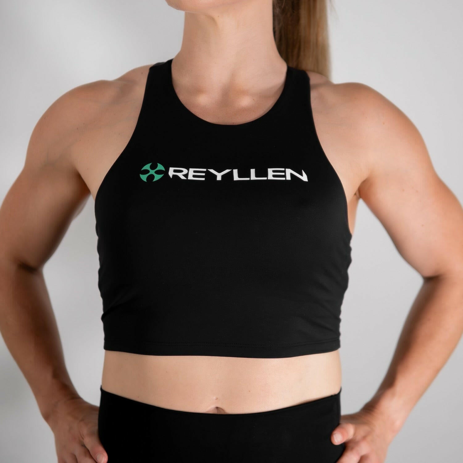 reyllen ladies racerback train top with built in bra black front view worn by woman