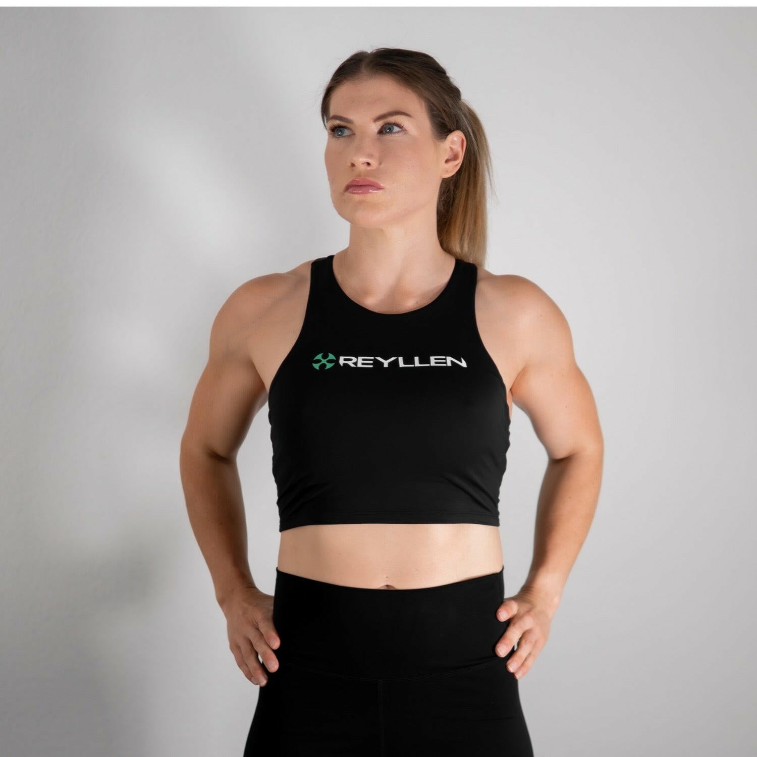 reyllen ladies racerback train top with built in bra black front view wider angle