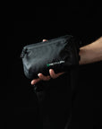 reyllen x-pac tech case pouch sling bag worn in hand