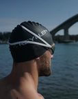 reyllen swim cap classic black shown on head with goggles