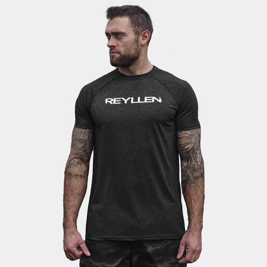 Reyllen m1 t-shirt. Polyester raglan style charcoal black mens modelled by man front view