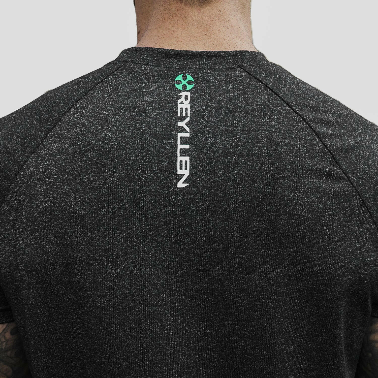 Reyllen m1 t-shirt. Polyester raglan style charcoal black mens modelled by man back logo detail view